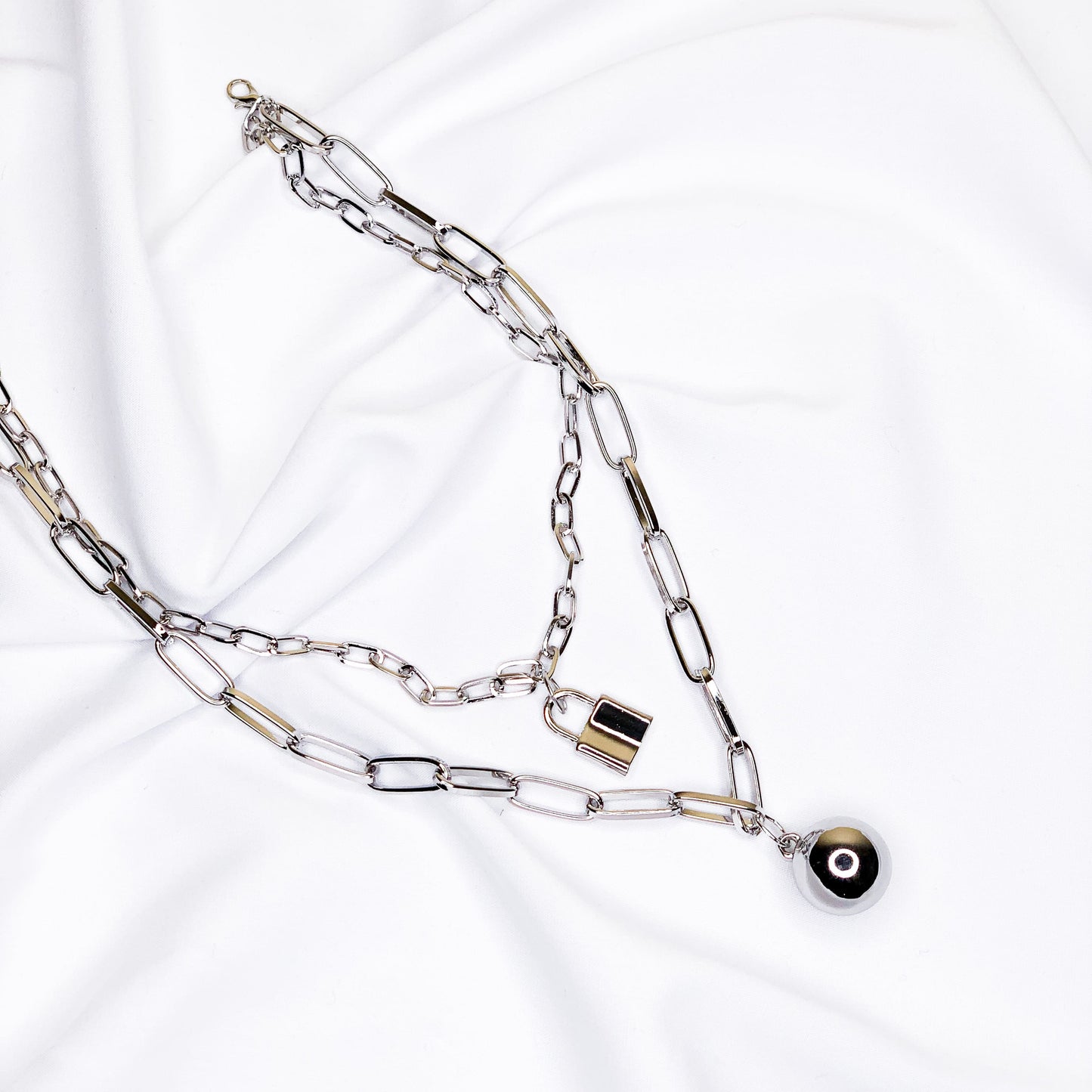 Chain necklace with ball and lock pendants